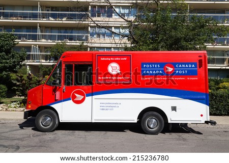 TORONTO, CANADA - 4TH SEPTEMBER 2014: A Canada Post Van outside a building during the day
