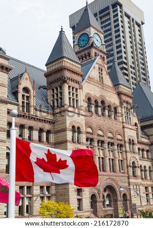 TORONTO, CANADA - 9TH SEPTEMBER 2014: Old Toronto City Hall during the day with the Canadian Flag flying