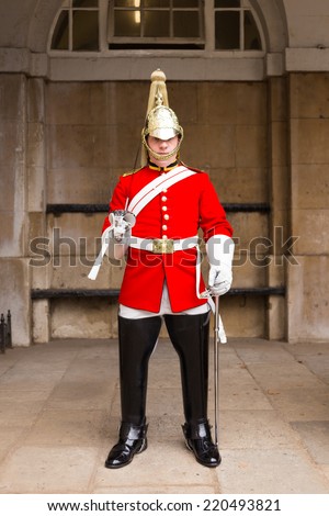 LONDON, UK - 26TH SEPTEMBER 2014: A Queens Guardsman standing to attention near Horse Guards Parade in London