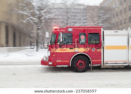 TORONTO, CANADA - 11TH DECEMBER 2014: Part of a Toronto Fire truck moving along a road in Toronto during the day