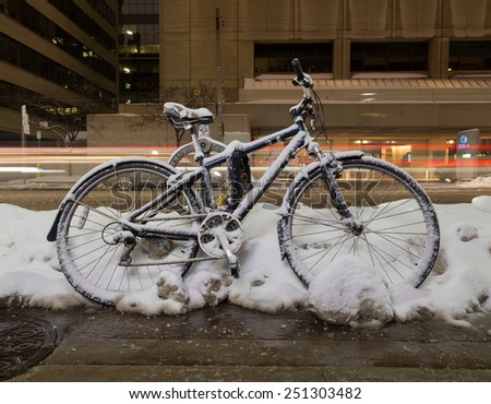 TORONTO, CANADA - 7TH FEBRUARY 2015: A closeup to a Bike at night covered in snow