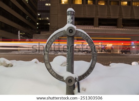 TORONTO, CANADA - 7TH FEBRUARY 2015: A closeup to a Toronto Bike lock at night covered in snow