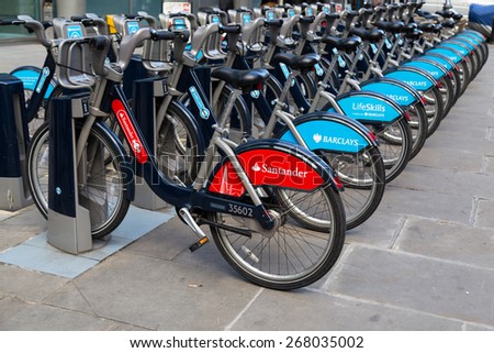 LONDON, UK - 25TH MARCH 2015:  A Santander public hire bike along with Barclays Bikes locked at the docking bays