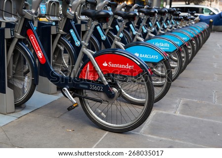LONDON, UK - 25TH MARCH 2015:  A Santander public hire bike along with Barclays Bikes locked at the docking bays