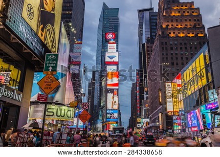NEW YORK CITY, USA - 31ST AUGUST 2014: Time Square at Dusk showing taxis going past and billboards lit up