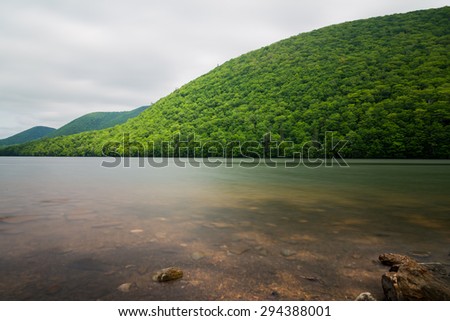Hills and lakes in Cape Breton Island during the day taken with a long exposure