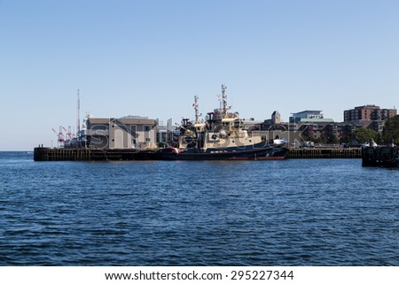 HALIFAX, CANADA - 3RD JULY 2015: A view of a ship on the Halifax Waterfront during the day in the summer. People can be seen.