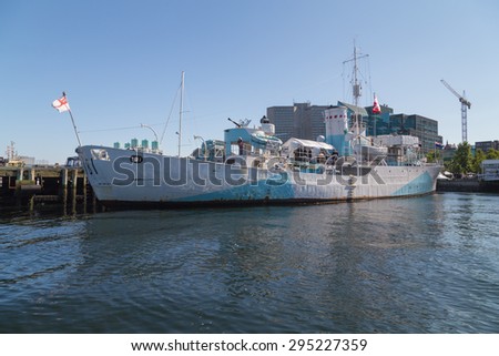 HALIFAX, CANADA - 3RD JULY 2015: A view of a ship on the Halifax Waterfront during the day in the summer. People can be seen.