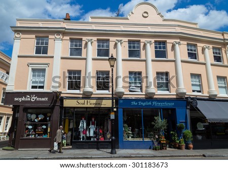 LONDON, UK - 21ST JULY 2015: Buildings and shops along Greenwich Church Street in London. People can be seen.