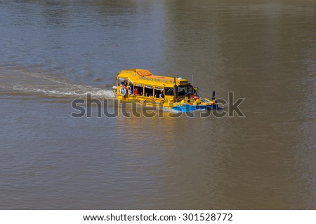 LONDON, UK - 18TH JULY 2015: A London Duck Tour boat in the River Thames during the day. People can be seen on the boat.