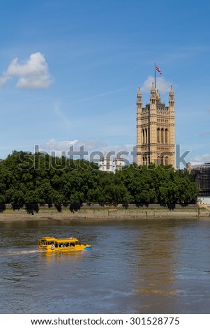 LONDON, UK - 18TH JULY 2015: A London Duck Tour boat in the River Thames during the day near Westminster. People can be seen on the boat.