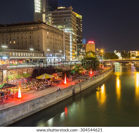 VIENNA, AUSTRIA - 4TH AUGUST 2015: People relaxing along the Danube Canal in Vienna at night.