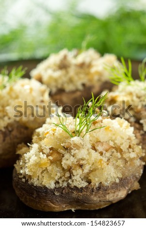 Stuffed baked mushrooms filled with bread crumbs, mushroom stems, onion and garlic.