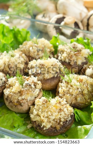 Stuffed baked mushrooms filled with bread crumbs, mushroom stems, onion and garlic.