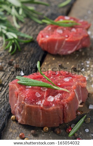Beef tenderloin on a wooden table.