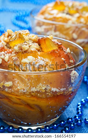 Baked apples with nuts, candied fruits, honey and sugar.