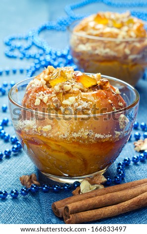 Baked apples with nuts, candied fruits, honey and sugar.