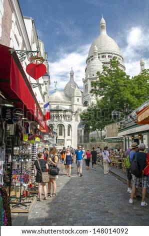 PARIS - JULY 2: The charming streets of Montmartre hill, July 2, 2012 in Paris. The quarter is full of art galleries, cafes and shops to walk about. It\'s one of the most visited landmarks in Paris