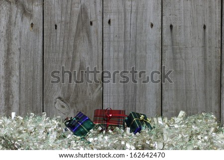 Colorful presents on white garland by rustic wooden fence