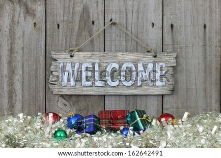 Country welcome sign with holiday decorations on white garland border