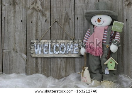 Wooden welcome sign with snowman