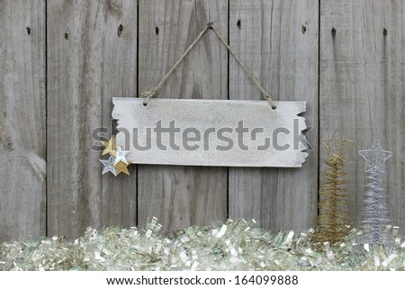 Wood fence with snow garland border and blank sign