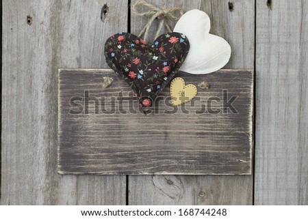 Blank brown wood sign with brown calico and muslin hearts