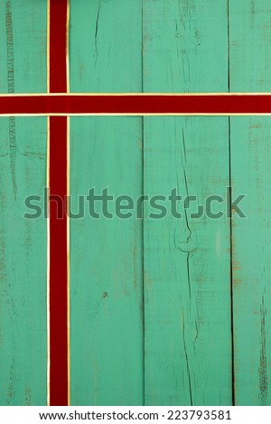Antique green weathered wooden sign with red and gold velvet ribbon border