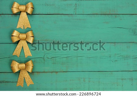 Gold bows border antique green old weathered Christmas background; wood sign