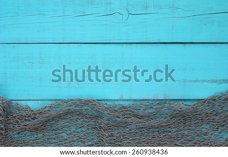 Blank antique teal blue aged wooden sign background with fish net border