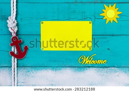 Blank yellow beach sign on rustic teal blue wooden background with welcome, sun, sand, red anchor and white rope border