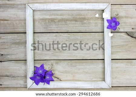 Rustic wooden sign with purple balloon flowers and white hearts