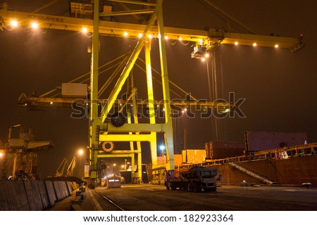 ODESSA NOVEMBER 27: Unloading loading containers on maritime vessels in Iyichevck seaport at night , around the clock, November 27, 2012 Odessa, Ukraine