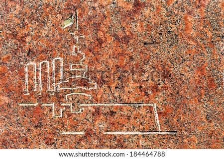 Natural red black polished granite. Beautiful colorful abstract interior decorative stone cracks and stains on the surface. Engraving military cruiser Aurora. Russian Revolution in 1917