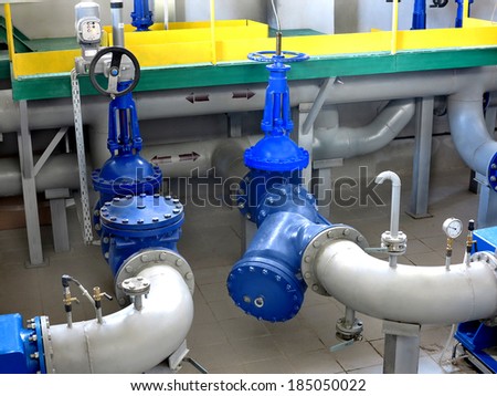Water pumping station, industrial interior and pipes. Water system valves, electronic motor control water supply
