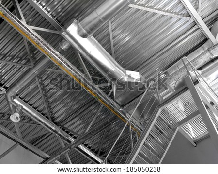 Metal ceiling in a modern industrial building . Ventilation system with a modern lighting shop