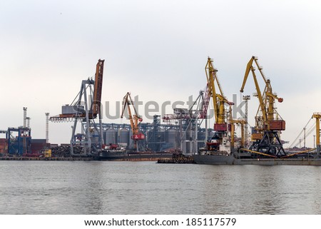 ODESSA, UKRAINE - 28 April: large cranes for loading  containers on large marine cargo ships at the container terminal in harbor of Odessa sea port on  foggy day , April 28, 2014 Odessa, Ukraine