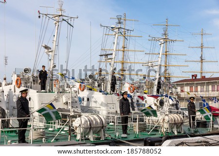 ODESSA, UKRAINE - APRIL 6: Maritime Boundary Navy, naval ships and sailors in the harbor Odessa. Military equipment of ships , guns and torpedo installation , marine flags , Ukraine, April 6, 2014 .