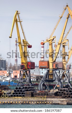 ODESSA, UKRAINE - April 8: large cranes for loading goods on large marine cargo ships at the container terminal in the port of Odessa sea port on a foggy day , April 8, 2014 Odessa, Ukraine