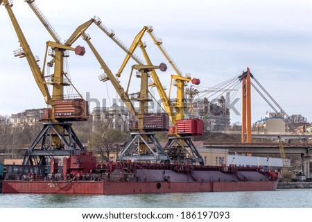 ODESSA, UKRAINE - April 8: large cranes for loading goods on large marine cargo ships at the container terminal in the port of Odessa sea port on a foggy day , April 8, 2014 Odessa, Ukraine