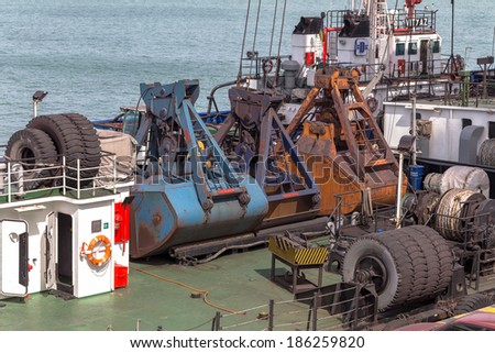ODESSA, UKRAINE - April 8: large floating marine crane for loading goods in dry bulk cargo ships in the harbor of Odessa sea port on a foggy day. Mechanisms and buckets , April 8, 2014 Odessa, Ukraine