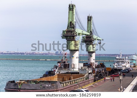 ODESSA, UKRAINE - April 8: large floating marine crane for loading goods in dry bulk cargo ships in the harbor of Odessa sea port on a foggy day. Mechanisms and buckets , April 8, 2014 Odessa, Ukraine
