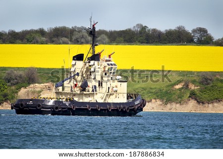 ODESSA, UKRAINE - APRIL 10: The tugboat is towing a raid on a cargo ship in the harbor seaport, April 10, 2014 Odessa, Ukraine