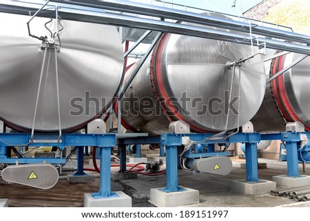 Large aluminum drums tanks and pipelines modern plant for the production of wine food industry. Fermentation tanks fragmentation of wine with grape juice