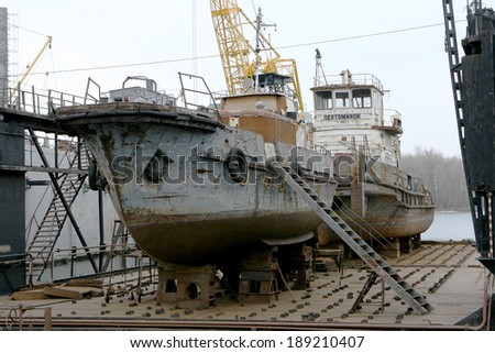 ODESSA - April 15: Old river trading port Ust -Danube . Human outdated repair river vessels , barges at the shipyard docks. Ancient Technology , April 15, 2014 Odessa, Ukraine
