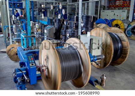 Fragment inside a modern plant producing power electric cables and optical fibers Interior of modern production line technology obsolescence Fragment inside a modern plant producing power electric cables and optical fibers Interior of modern production line technology obsolescence