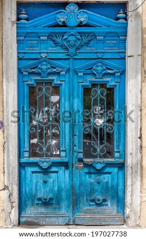 Old wooden door covered with cracks, worn paint. An ideal base for creative design fashion trend in modern development