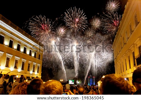 ODESSA, UKRAINE - September 2, 2011: Numerous crowd and residents enjoyed watching the festive fireworks at night city streets September 2, 2011 in Odessa, Ukraine.