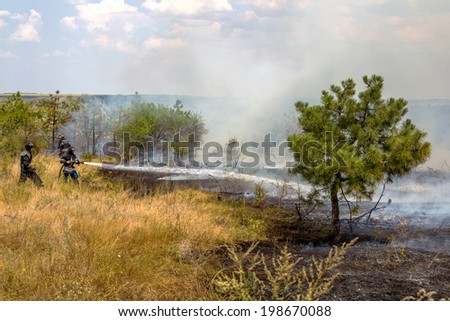 Odessa, Ukraine - August 4, 2012: Severe drought. Fires destroy forest and steppe. Firefighters in protective clothing quenched with water from hydrants pockets, August 4, 2012 in Odessa, Ukraine.