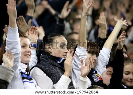 ODESSA, UKRAINE - July 10, 2013: emotional football fans support the team at the stadium during a game of football club Chernomorets, July 10, 2013, Odessa, Ukraine